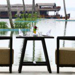 Aveda Resort Kumarakom outdoor space with houseboat in the background