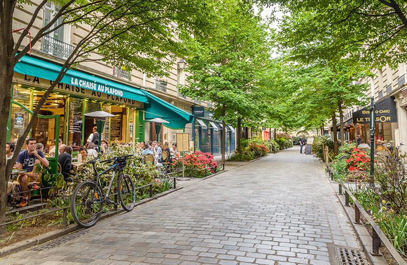 A quiet street with restaurants in the bohemian Marais district of Paris (by Alexandre Rotenberg)
