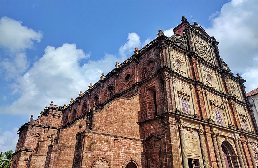 Red Stone Church in Goa against a sunny sky