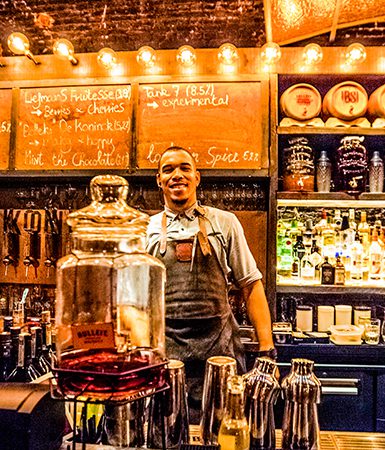 Friendly bartender will entertain patrons at Black Smoke bar & BBQ restaurant by Sung Studio