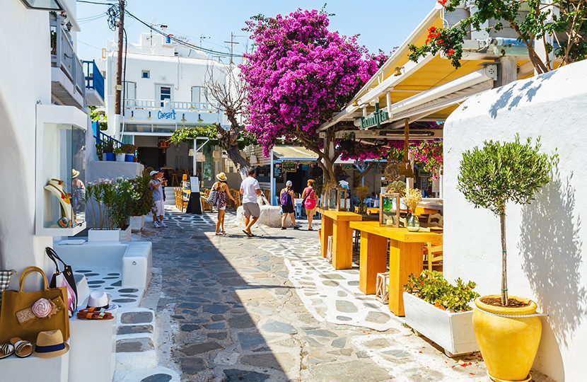 Shops and bars by street at the famous tourist spot of downtown on island Mykonos by Littleaom