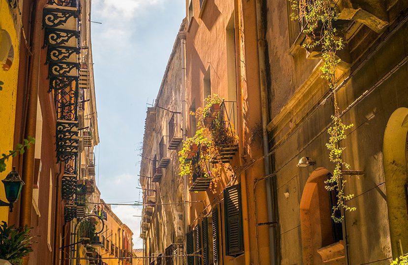 The narrow, cobblestone-paved streets of old town Cagliari are lined with quaint, traditional homes and scenes of everyday Italian life.