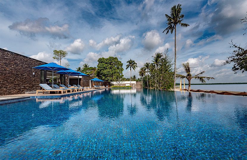 Recline on the loungers at the main in nity pool