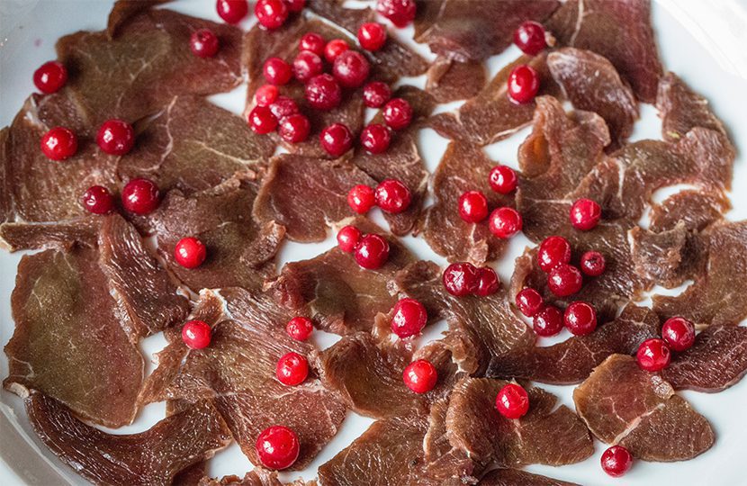 Reindeer is topped with lingonberries, and then eventually with a hearty gravy - 