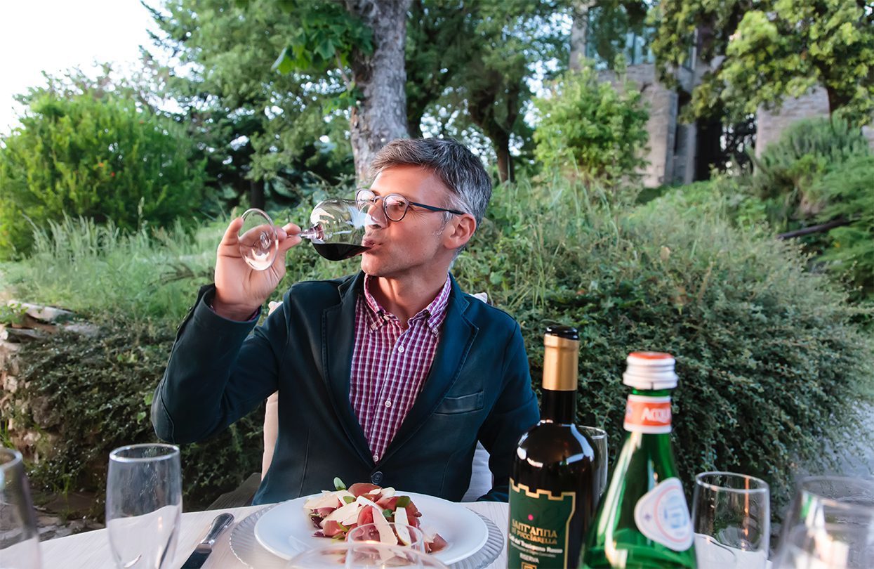 Wine connoisseur Simone Carlotti sampling a glass of Sant’Anna di Puccuarella - 