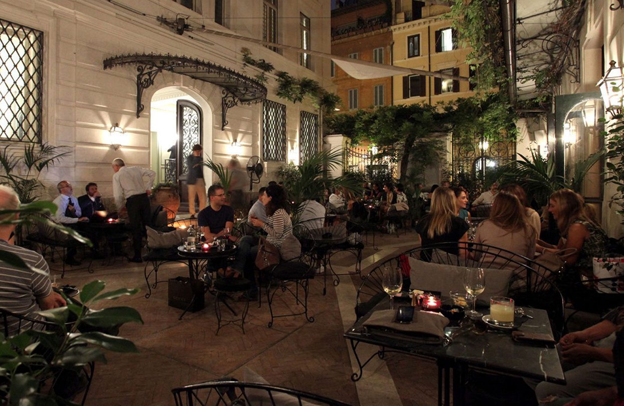 Hotel Locarno's intimate outdoor lounge by night