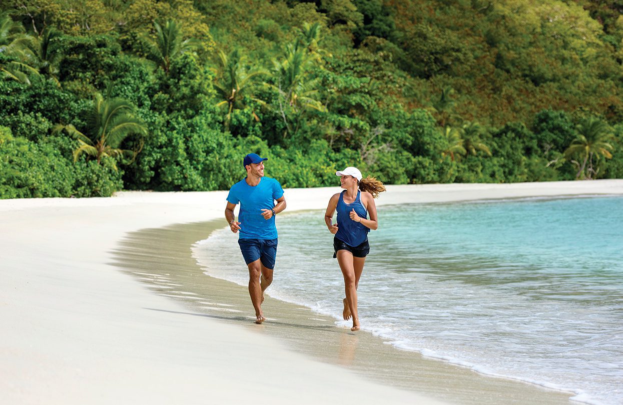 Couple beach run, image by Tourism Fiji
