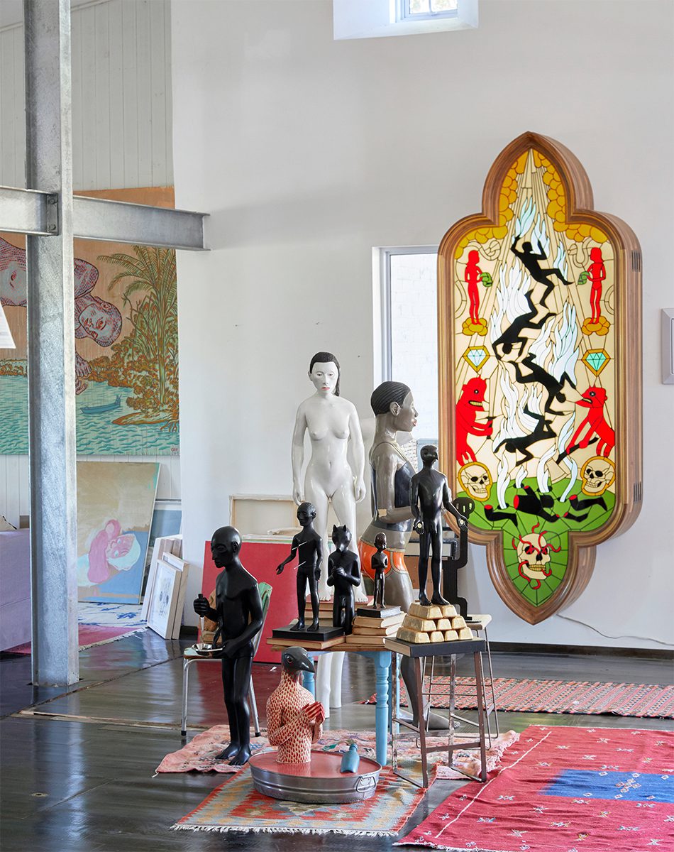 Collected sculptures and artwork by Botes creates a layered vignette in his studio and home