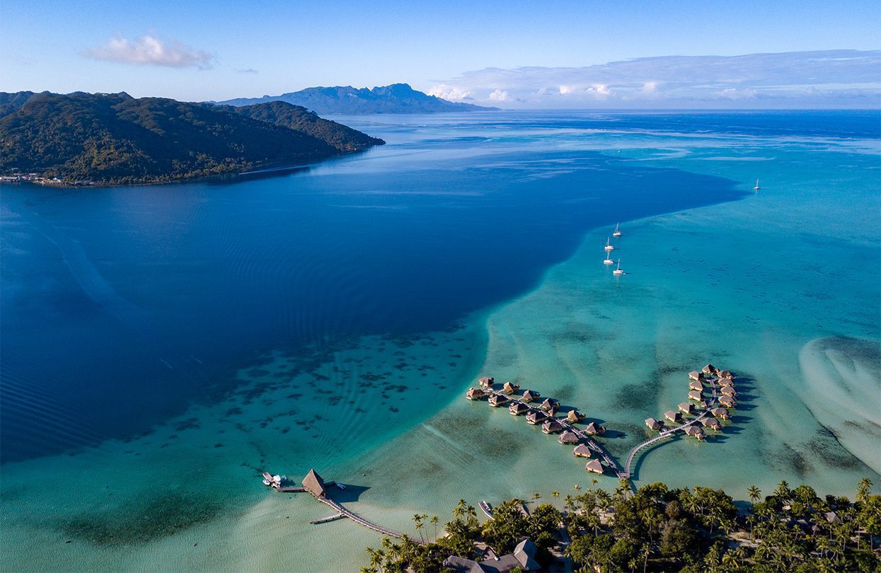Overwater bungalows in the lagoon of Moorea in French Polynesia by Andrea Izzotti