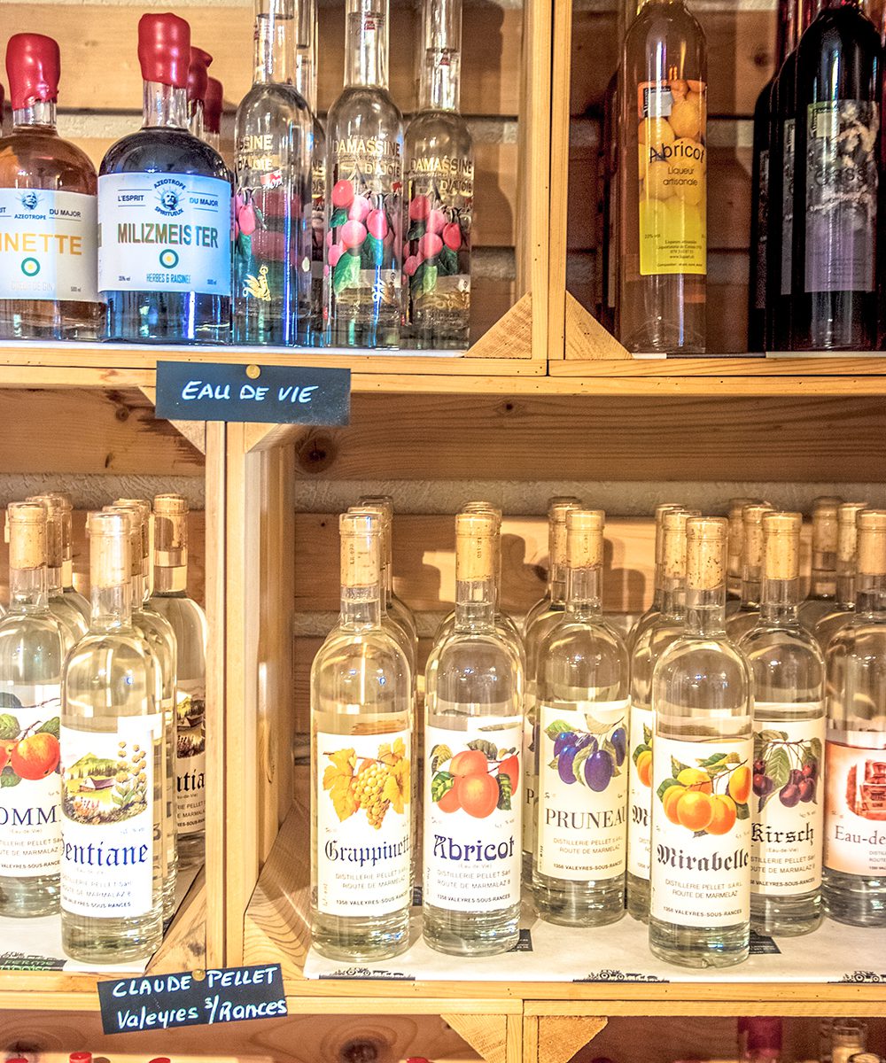 Distilled spirits line the shelves at La ferme vaudoise