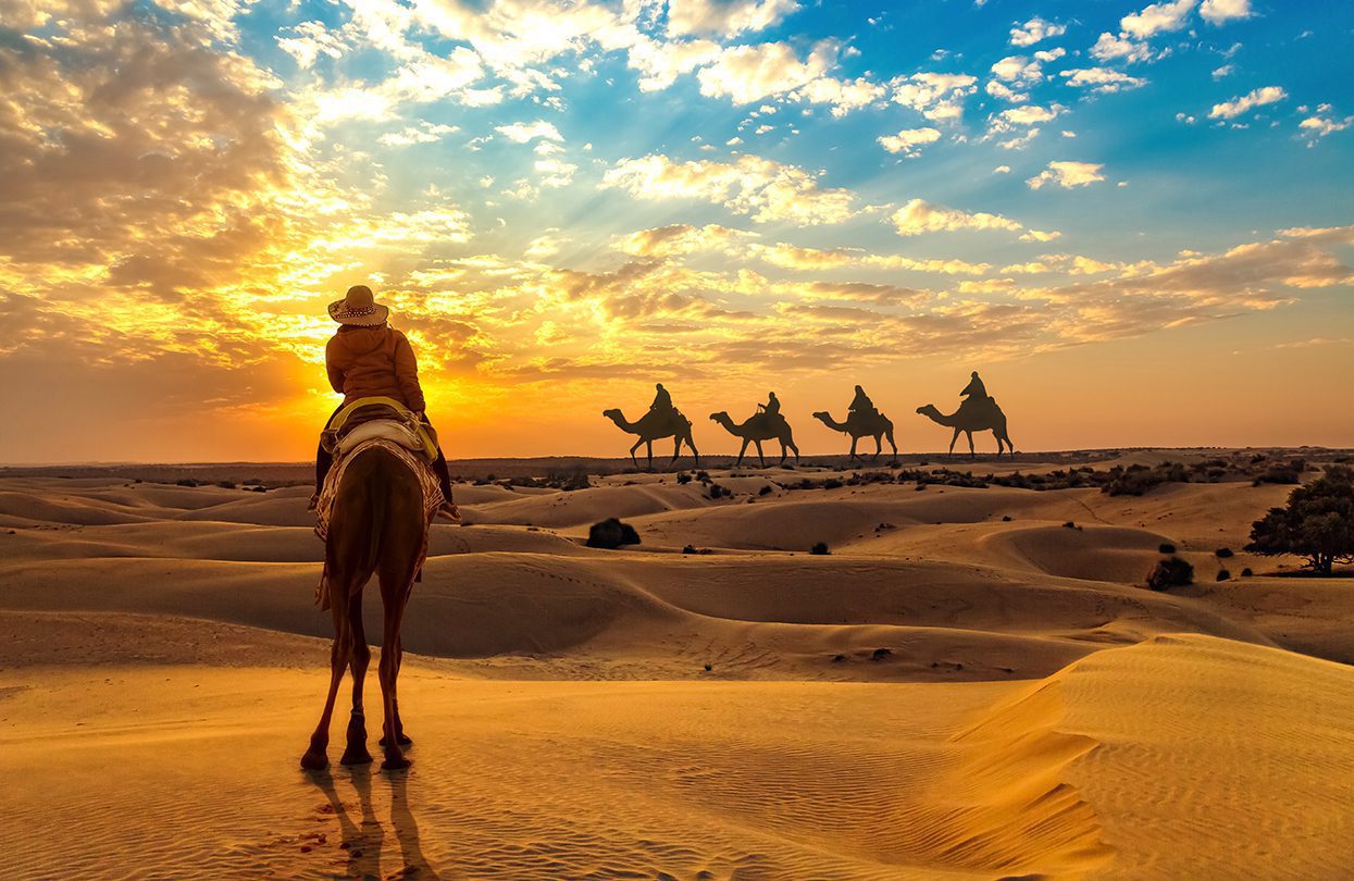 Female tourist on camel safari at the Thar desert Jaisalmer, by Roop_Dey