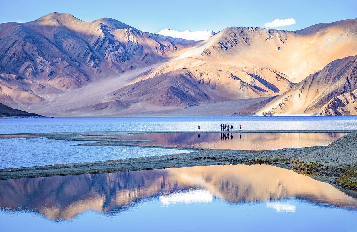 Landscape with reflections of the mountains on the lake named Pagong Tso, photo by Chris Piason