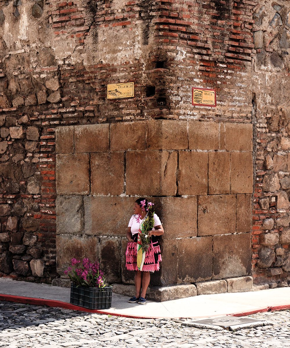 Woman selling flowers on a street corner, Antigua, photo by rokosvisualvibes
