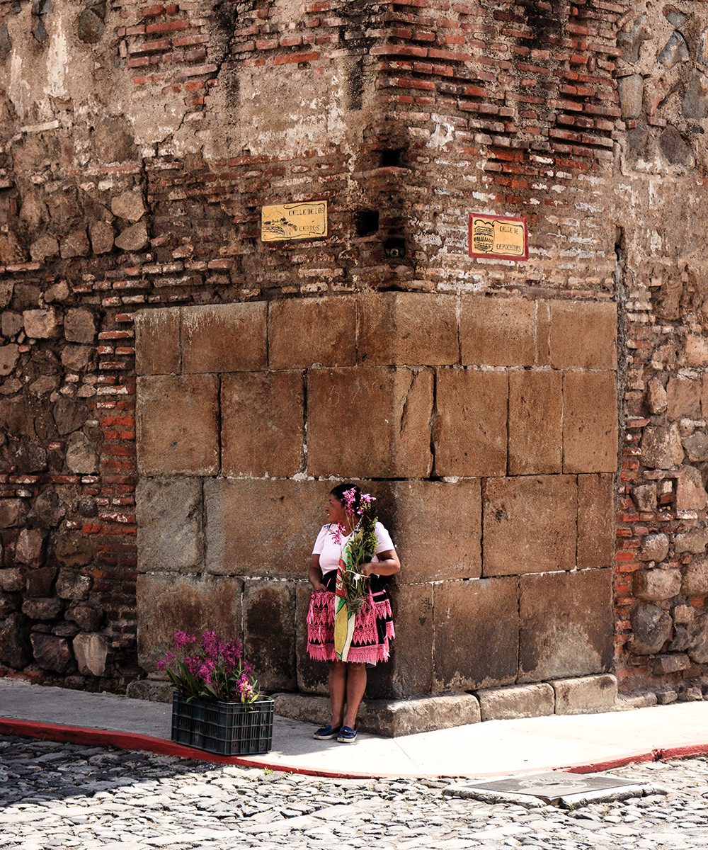 Woman selling flowers on a street corner, Antigua, photo by rokosvisualvibes