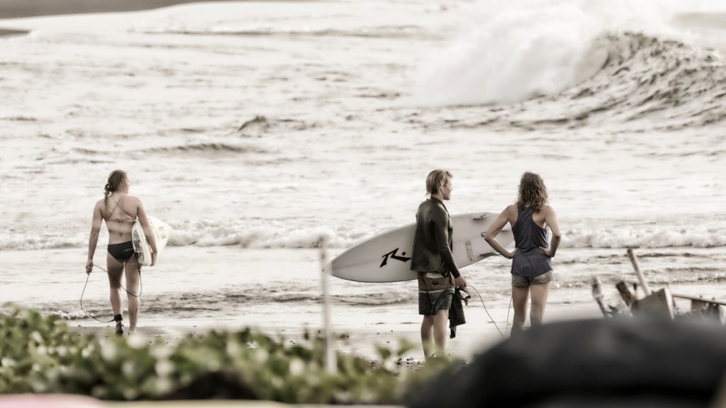 Surfers assessing the swell off the untouched east coast of Bali, image by Peter Mylonas