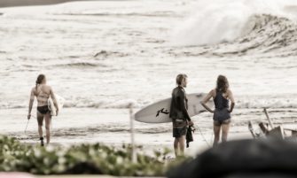 Surfers assessing the swell off the untouched east coast of Bali, image by Peter Mylonas