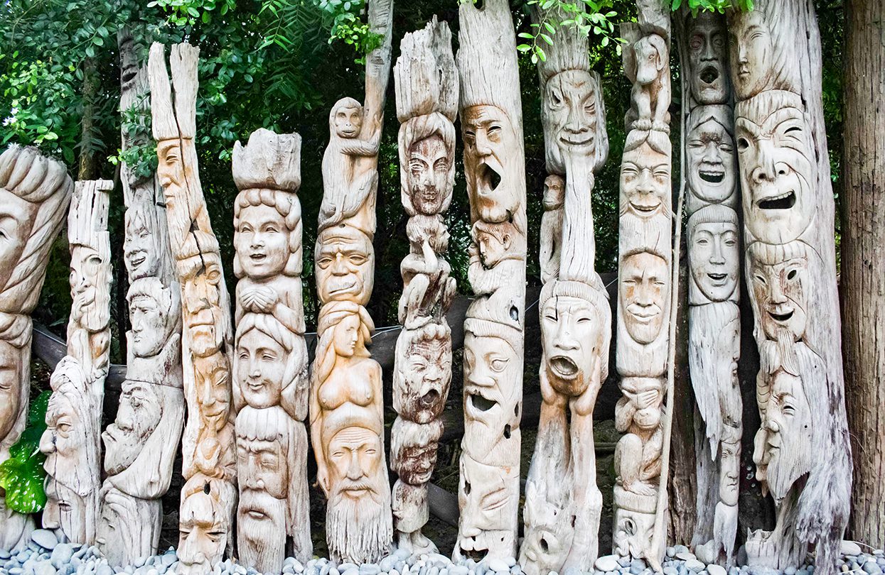 Wood carved with different faces line in a row to form a fence, Kamay na Bato Art and gallery in Luna La Union, image by Chema Grenda