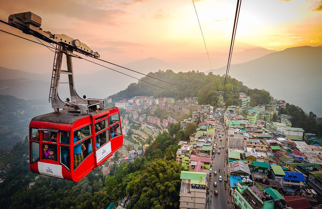 Tourists enjoy a ropeway Gondola ride over Gangtok city during sunset, Sikkim, image by Vivek BR