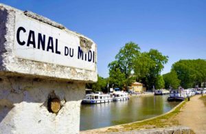 Southern France, Canal de Midi at the village of Capestang. Focused at the sign with the name of the canal, photo by By robert paul van beets, shutterstock