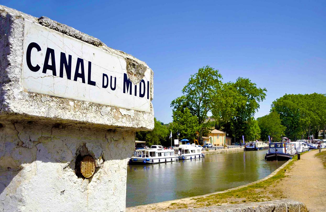 Southern France, Canal de Midi at the village of Capestang. Focused at the sign with the name of the canal, photo by By robert paul van beets, shutterstock