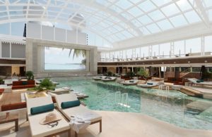 The indoor pool on Explora I with a retractable glass roof will allow swimming and poolside relaxation in any weather