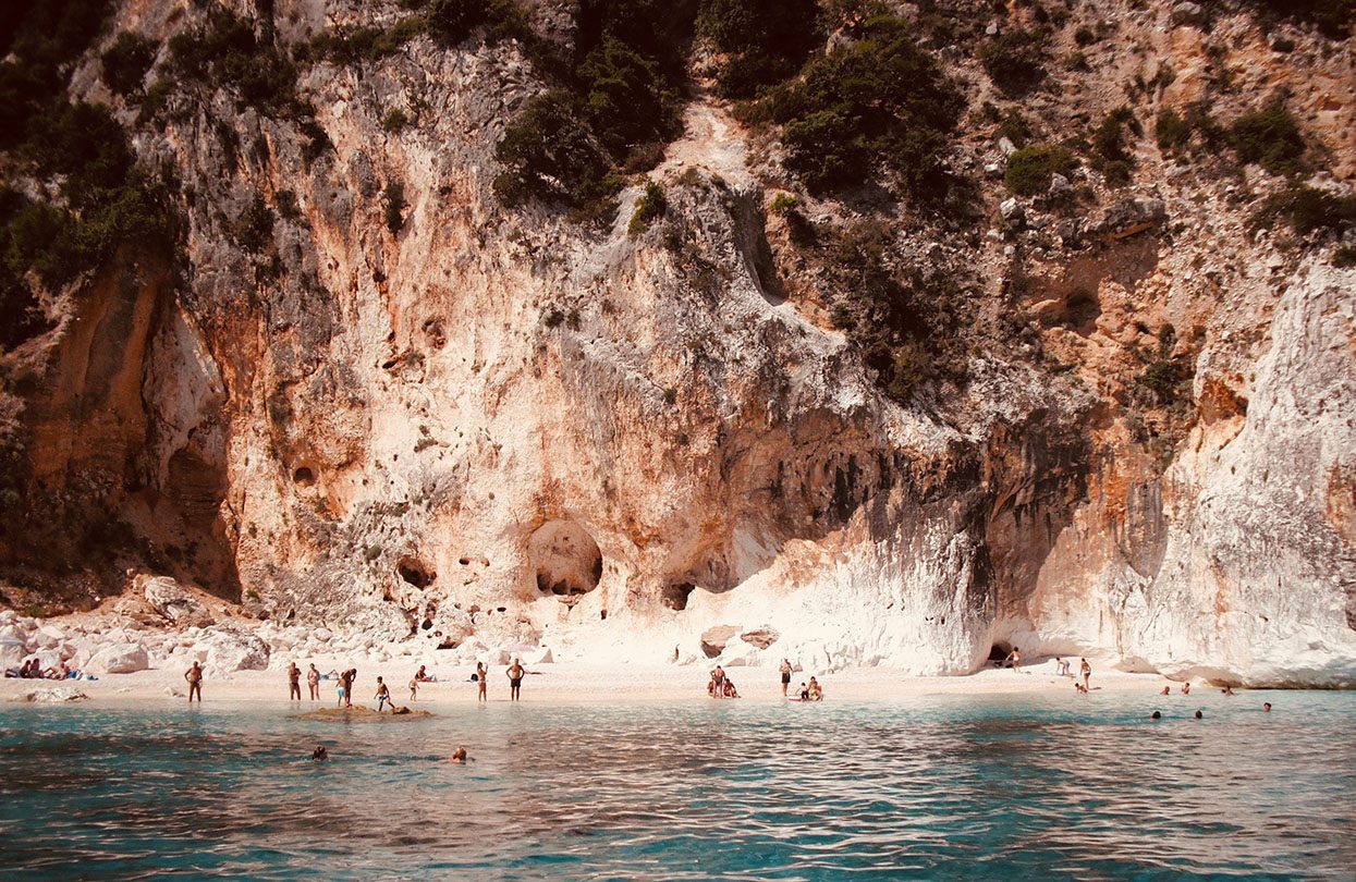 Tourist by the Seashore near Rock Formation, Baunei, Photo by Martina Amaro, Pexels