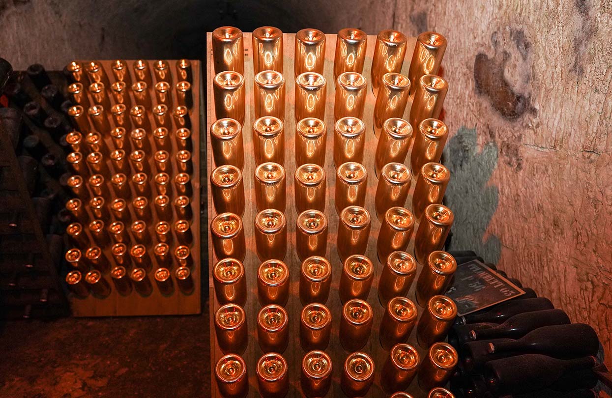Champagne bottles in pupitre in Reims, France, image by Leonard Zhukovsky, Shutterstock